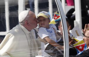 20150921cnsnw01901 1 300x194 - Pope Francis kisses child as he arrives to celebrate Mass in Revolution Square in Holguin