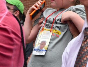 Small pilgrim held aloft by dad while waiting in line for Mass Sept. 27. (Sun photo | Katherine Long)