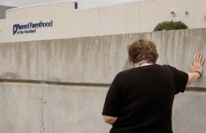 20150730cnsto0016 1 300x194 - Woman prays in front of Iowa Planned Parenthood facility