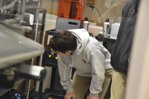Grimes students check out pieces in progress on the 3D printers at SU's MakerSpace. (Sun photo | Katherine Long)
