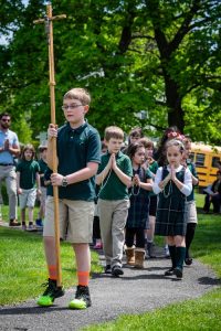 Students from All Saints School processing Thursday to the Marian Shrine at St. Joseph Church in Endicott to recite the rosary and crown the Blessed Mother with flowers. -Sun photos | Chuck Haupt