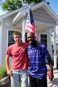 A Tiny Home for Good, Inc. Executive Director Andrew Lunetta and first resident Dolphus Johnson take a moment outside his new home July 22. (Sun photo | Chuck Wainwright)
