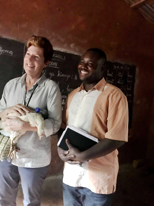 Dr. Dale Avers and Papy Amani recieve the Gift of a Chicken from the Women Literacy Group color - Fierce as a mother