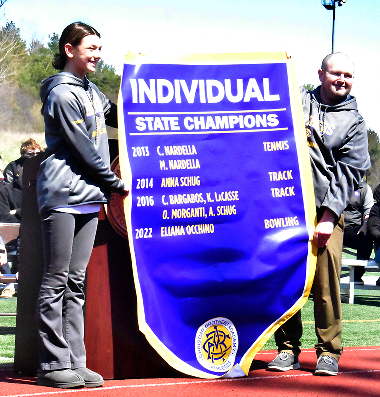Eliana and coach adjusted - Brothers’ state-champs banner gets an upgrade!