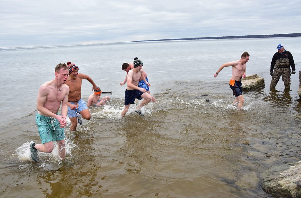 Shivering shoreline! Priests, buddies take polar plunge