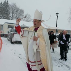 Bishop Robert J. Cunningham and the Divine Mercy Parish community braved the elements for a ground blessing and breaking April 3, 2016. The parish is building a new church for its faith community.
(Sun photo | Dave Garrett)