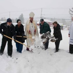 Bishop Robert J. Cunningham and the Divine Mercy Parish community braved the elements for a ground blessing and breaking April 3, 2016. The parish is building a new church for its faith community. Pictured are parishioners Paul and Jean Postell; Bishop Cunningham; parishioners Dick and Barb Murphy; and seminarian and parishioner Nate Brooks.
(Sun photo | Dave Garrett)