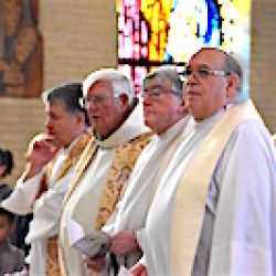 Our Lady of Lourdes Parish's parochial vicar Father Tom Servatius and  former pastor Father Donald Karlen stand with Father Paul Drobin and Msgr. James Lang during Mass to celebrate the parish's 100th anniversary May 5, 2019. (Sun photo | Katherine Long)