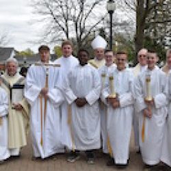 Bishop Robert J. Cunningham stands with altar servers following Our Lady of Lourdes Parish's 100th anniversary Mass. Also pictured are (back row, from left) seminarian Dennis Walker, pastor Father Joseph Salerno, Msgr. James Lang, and parochial vicar Father Tom Servatius. (Sun photo | Katherine Long)