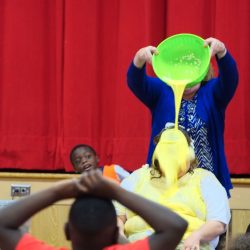Blessed Sacrament School Principal Andrea Polcaro gets egged June 13. She promised her students they could egg her if they read 20,000 books over the course of the school year. (Sun photo | Chuck Wainwright)
