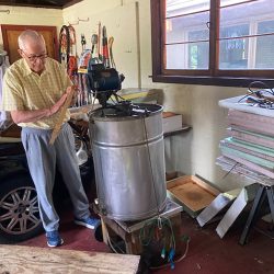 Joe Cerwonka sets up his extraction equipment to harvest the raw honey. 
