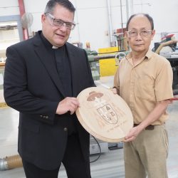 Bishop-elect Douglas J. Lucia stands with Stickley Cabinet Marker Dung Tran, who provided final machining on the bishop-elect's coat of arms and also built the cathedra that it will grace. (Sun photo | Chuck Wainwright)