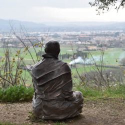 A statue of St. Francis on the grounds of San Damiano Church is set above the landscape of Assisi. (Sun photo | Katherine Long)