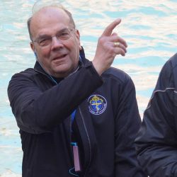 Bishop Cunningham tosses a coin over his shoulder and into the Trevi Fountain. (Photo courtesy William Crist)